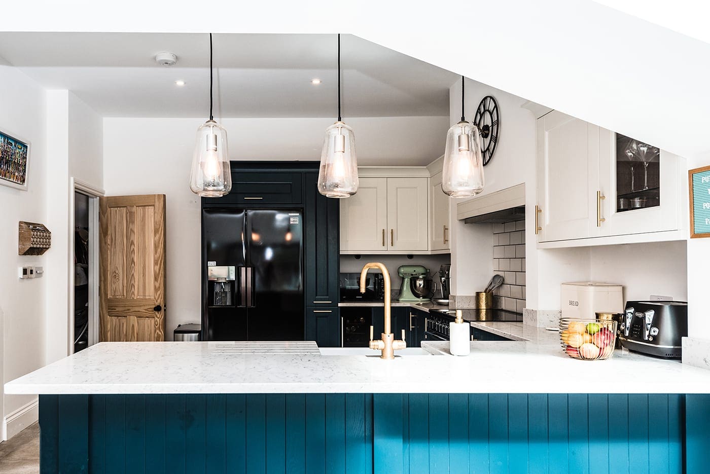 Modern white and blue kitchen with hanging lights