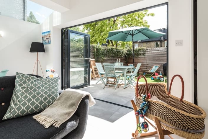 Opened glass wall between living room and garden