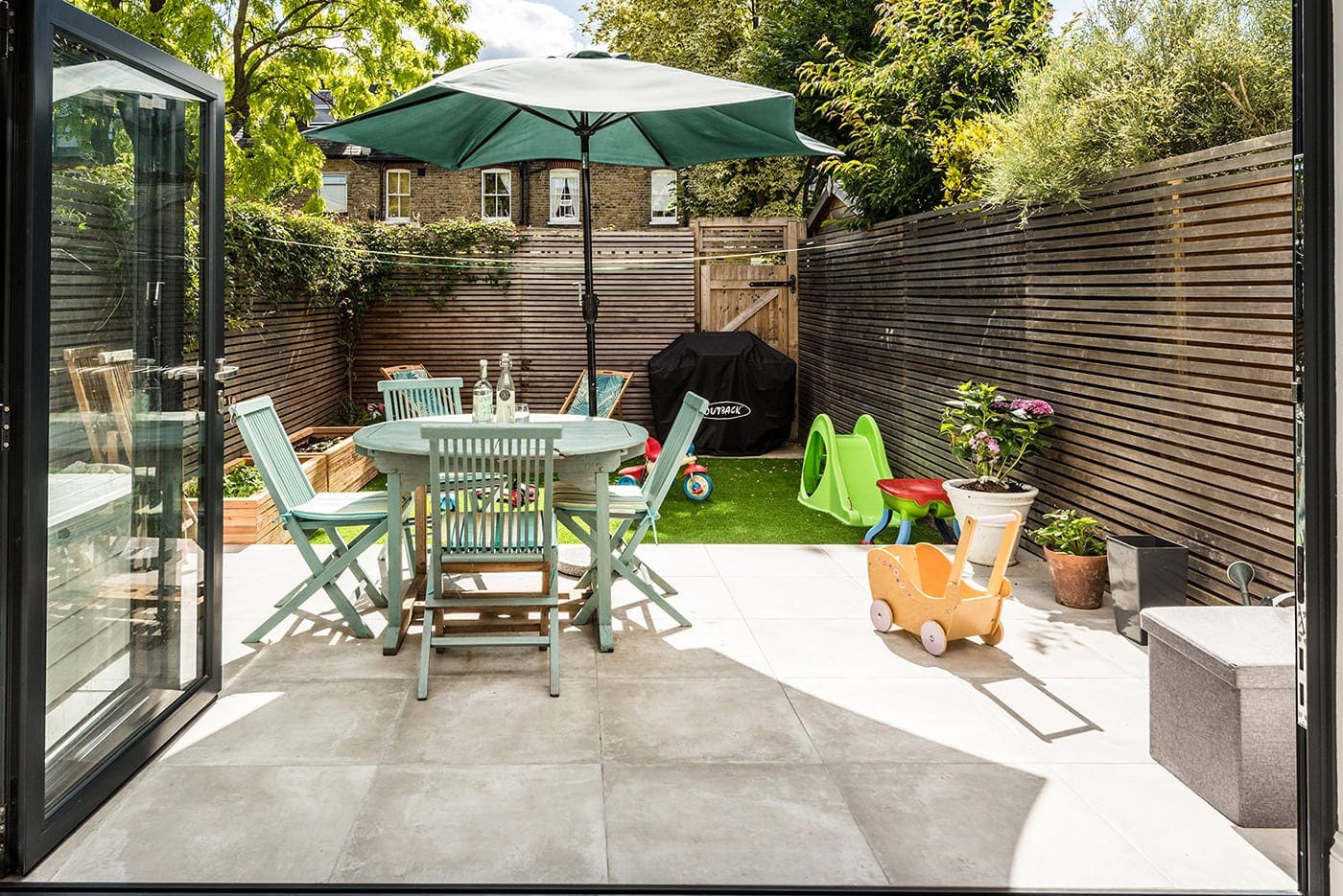 Back garden with table and kids play area