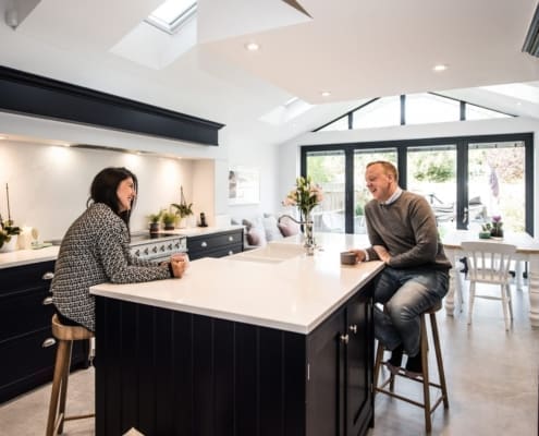 Happy couple drinking tea in modern kitchen