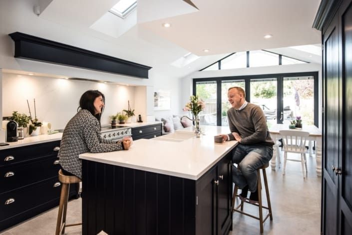 Happy couple drinking tea in modern kitchen