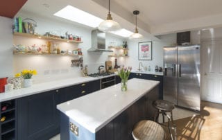 Dark blue kitchen with white worktops