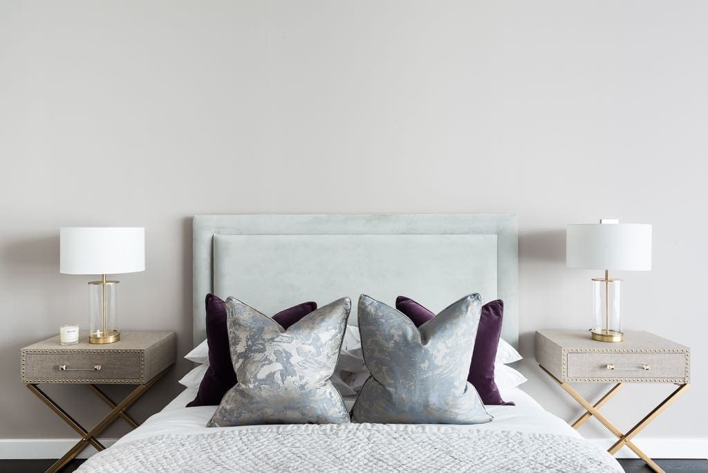 Velvet grey bed with golden bedside tables