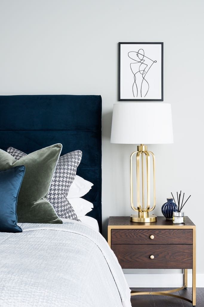 Bedside table with outline artwork and gold vase