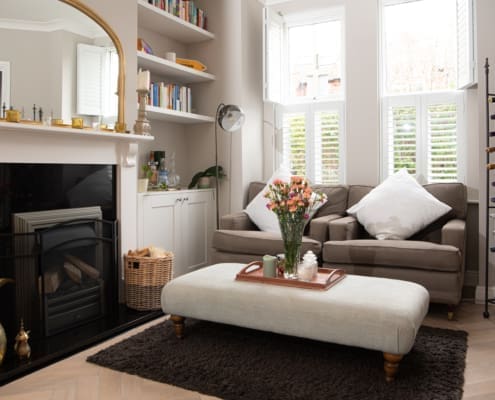 Living room interior with wine rack, log burner and gold mirror