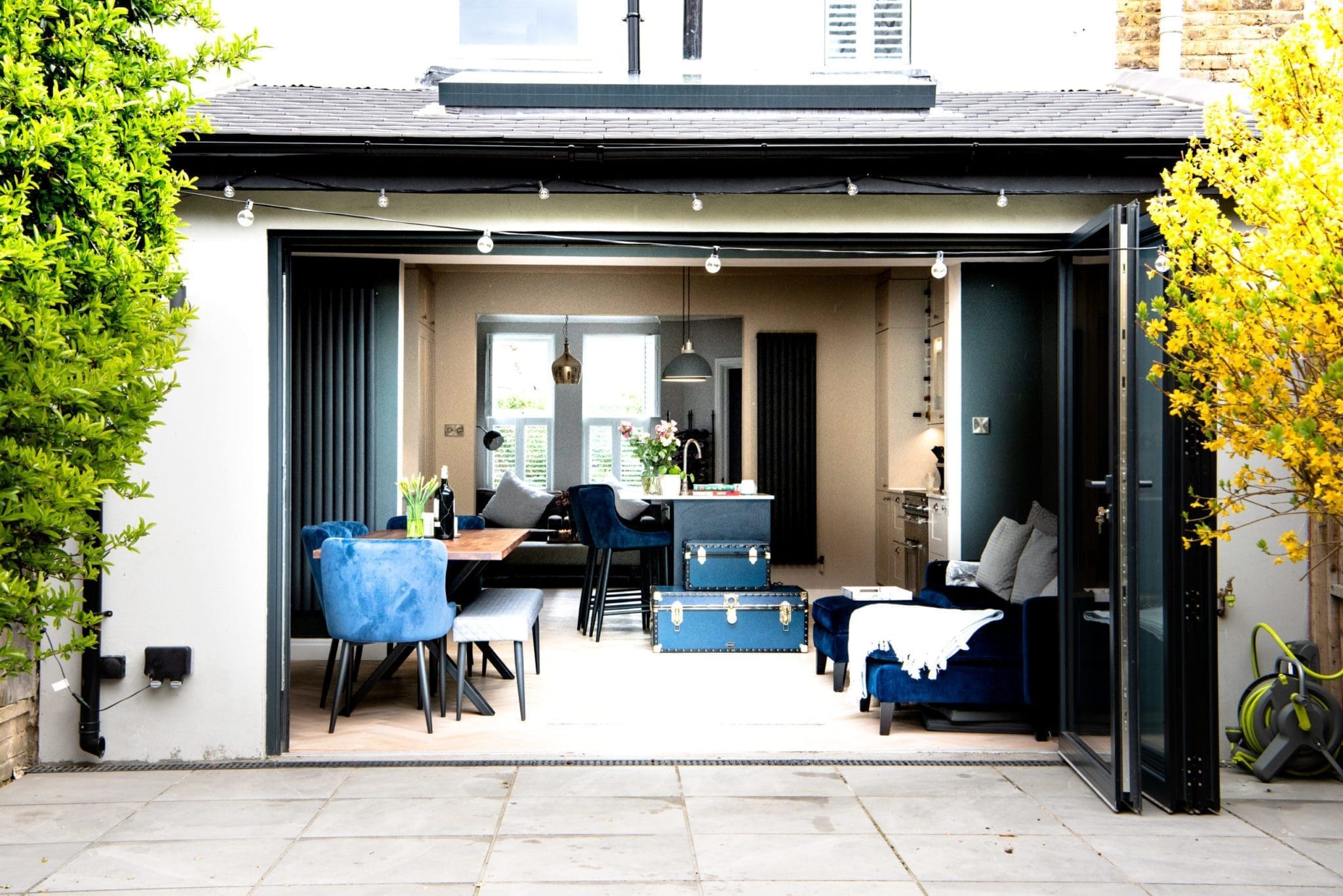 Opened glass wall from garden to open plan living space