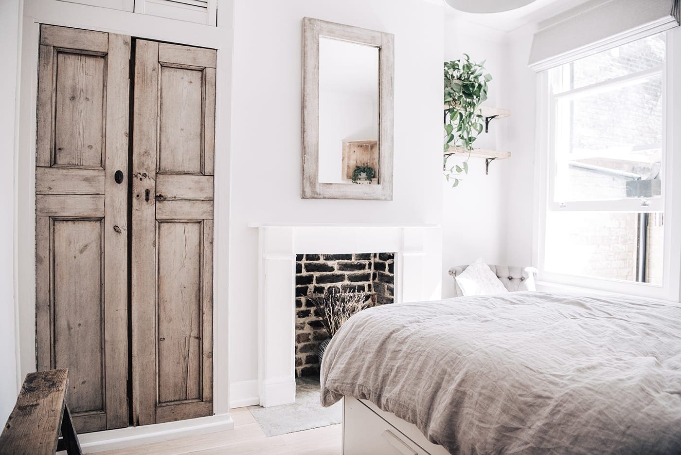 White vintage bedroom with wooden decor