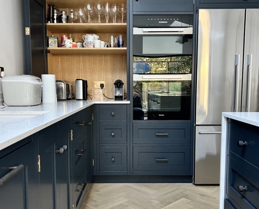 A modern kitchen with dark blue cabinets